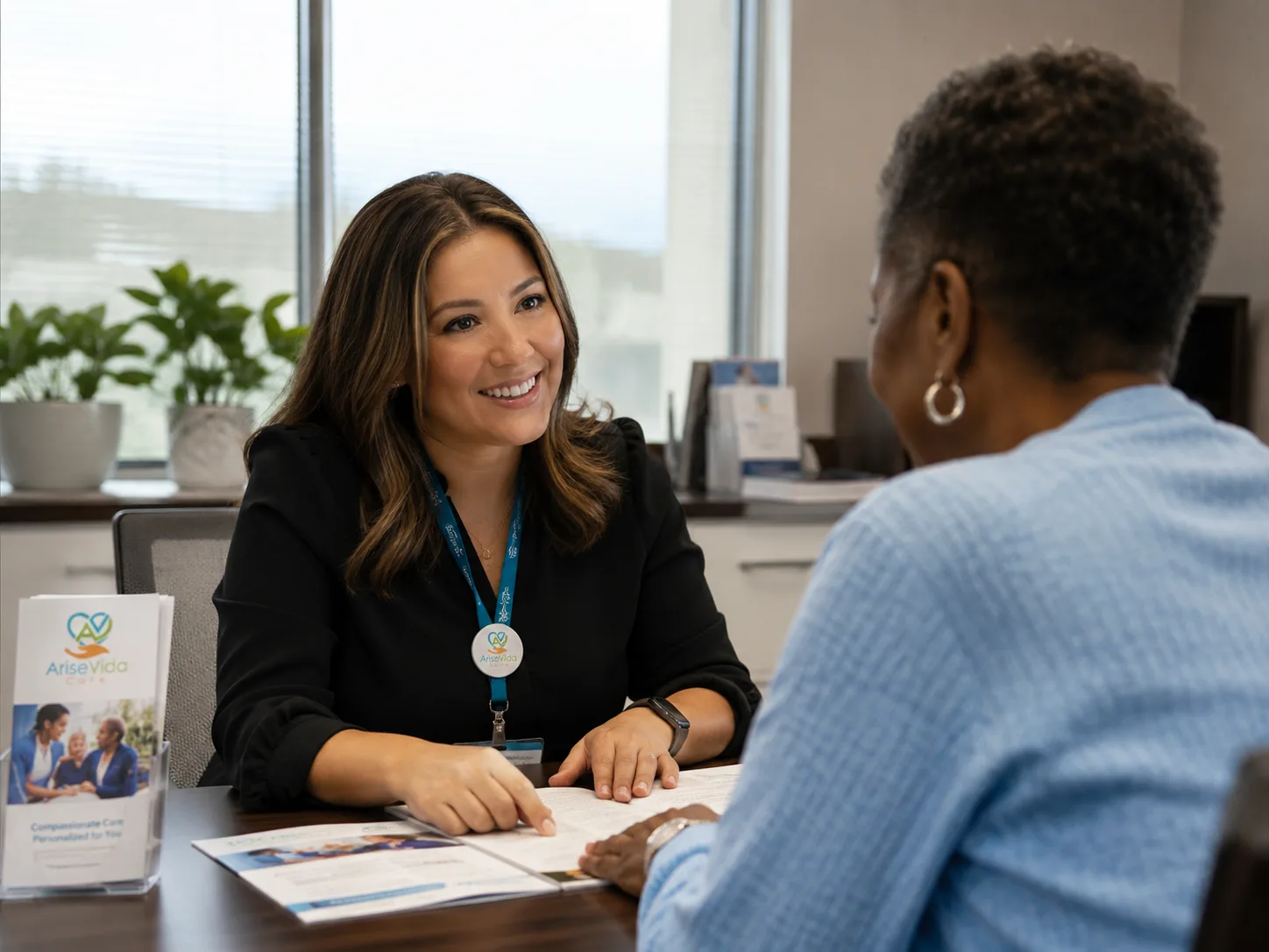 AriseVida Care team member meeting one-on-one with a patient to talk through her questions and next steps.