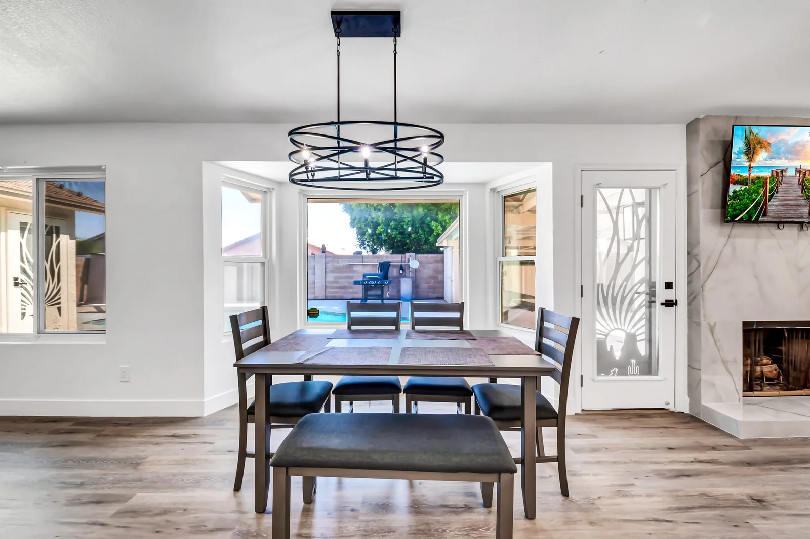 Bright, remodeled dining area of a supportive recovery residence with a wooden table and natural light.
